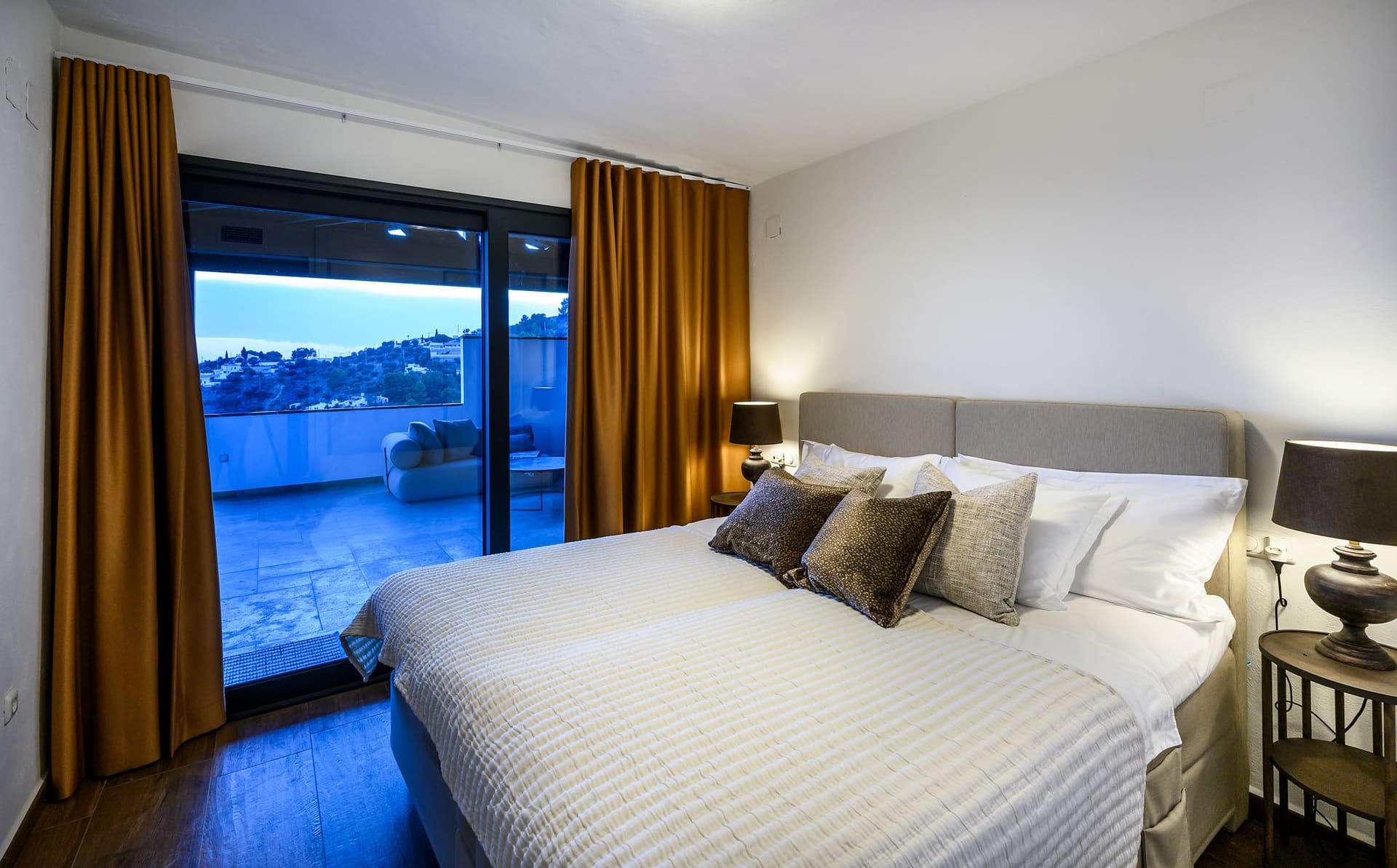 A bedroom at El Cortijo with glass doors opening onto the terrace.
