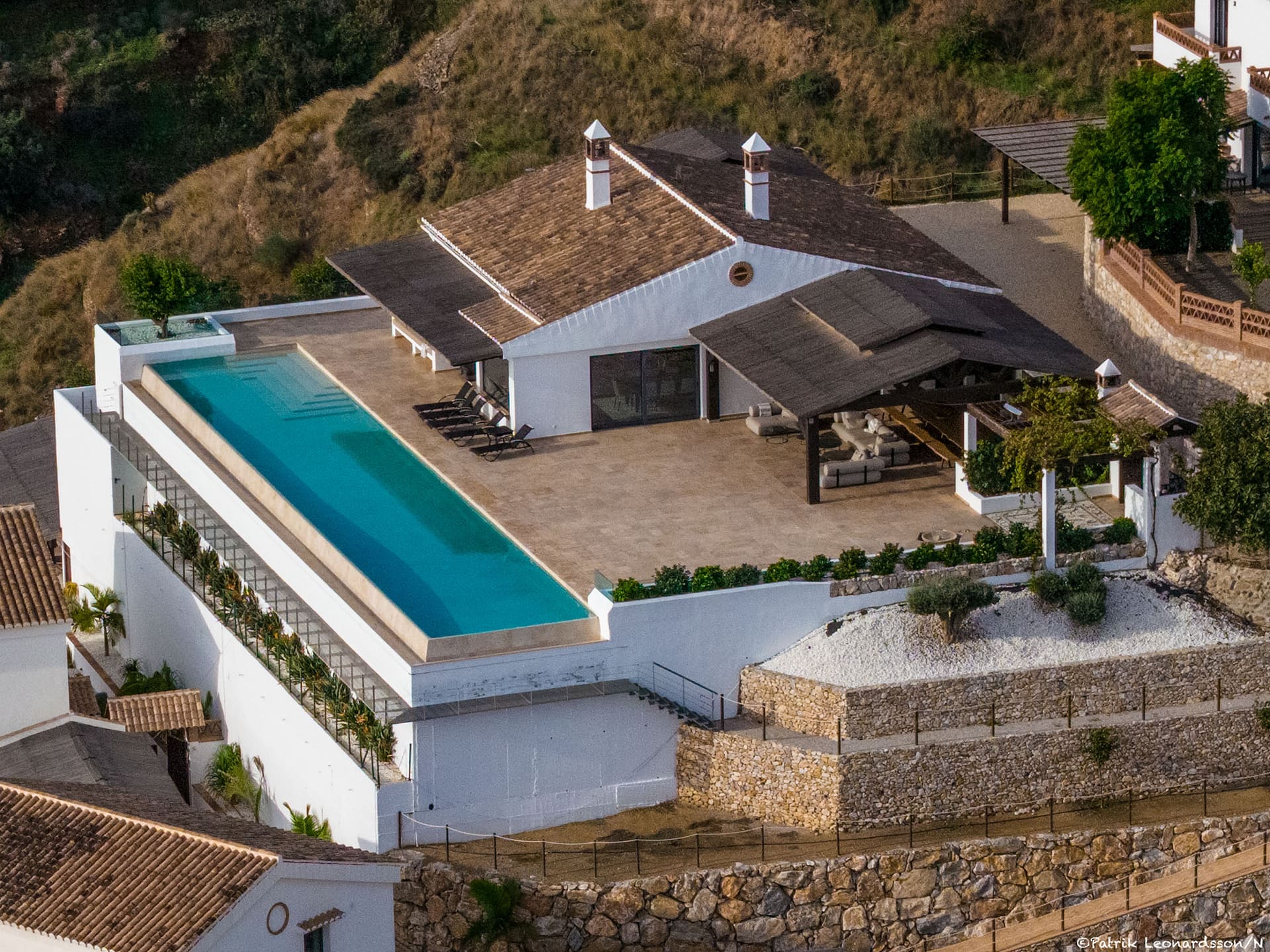 El Cortijo from above, the long infinity pool running along the edge of the terrace.