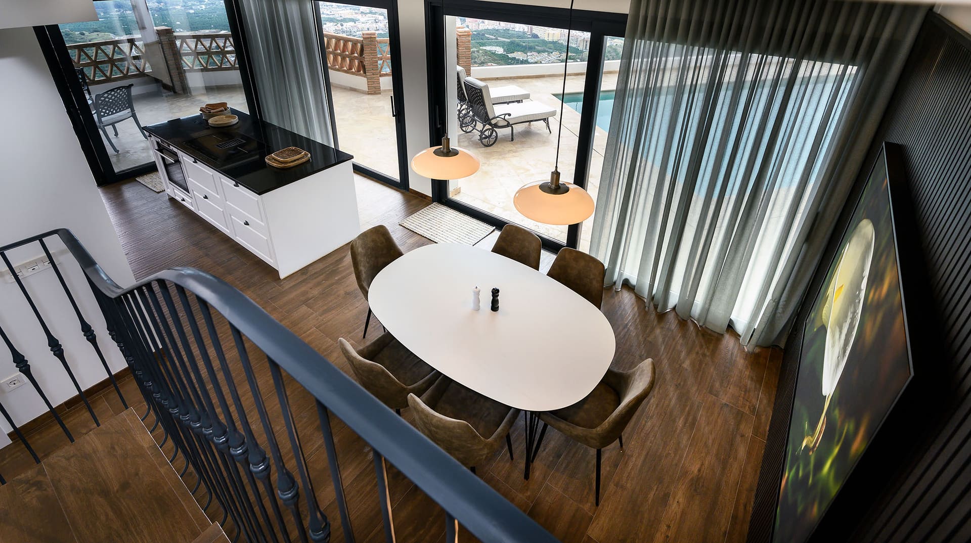 The dining area at Villa Limón, a round table by tall windows onto the terrace.