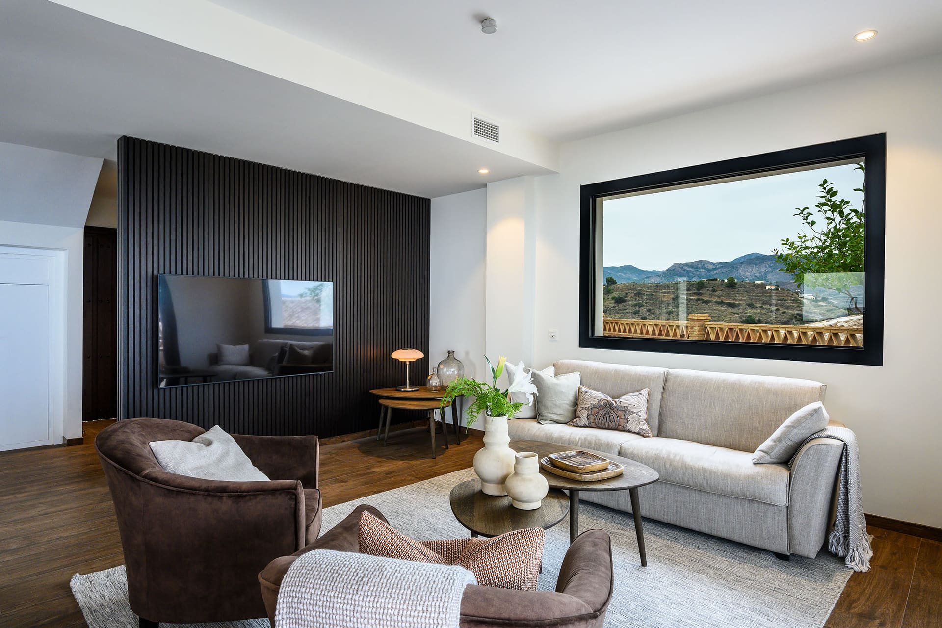 The living room at Villa Limón, a wide window framing the hillside.
