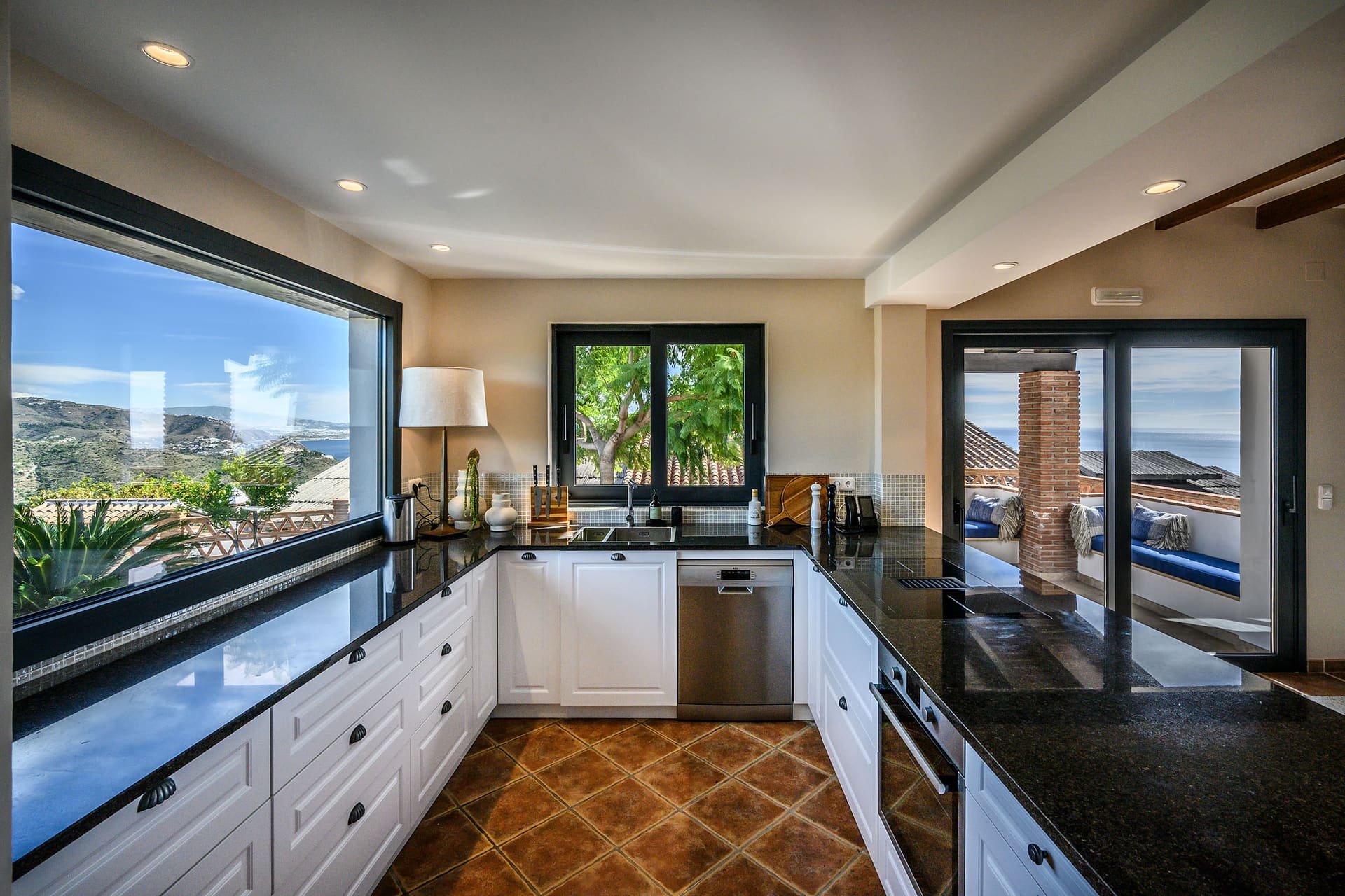 The kitchen at Villa Mango, windows over the hillside on two sides.