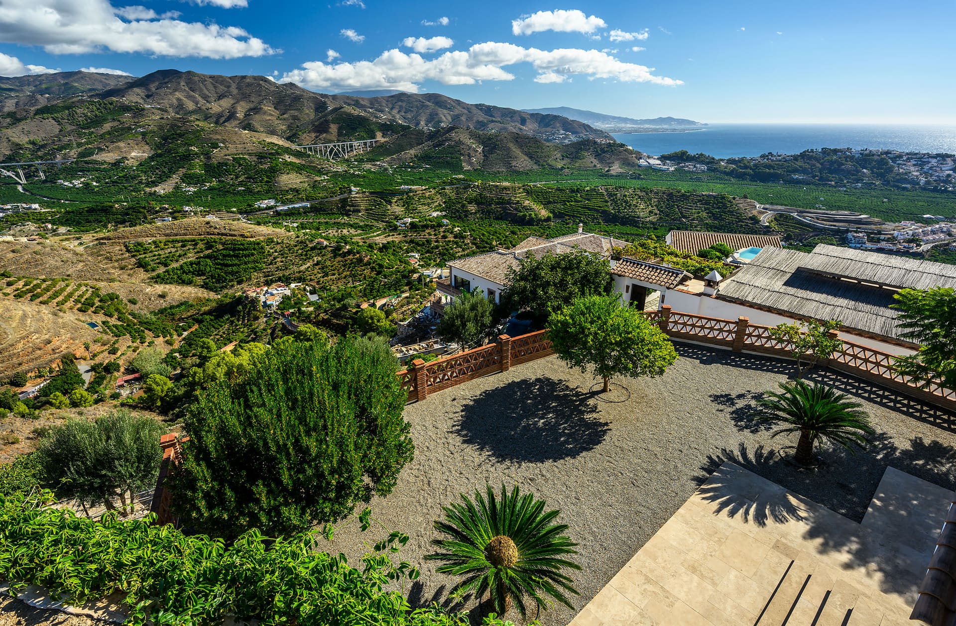 The view from Villa Mango over the garden, the terraced hills and the coast.