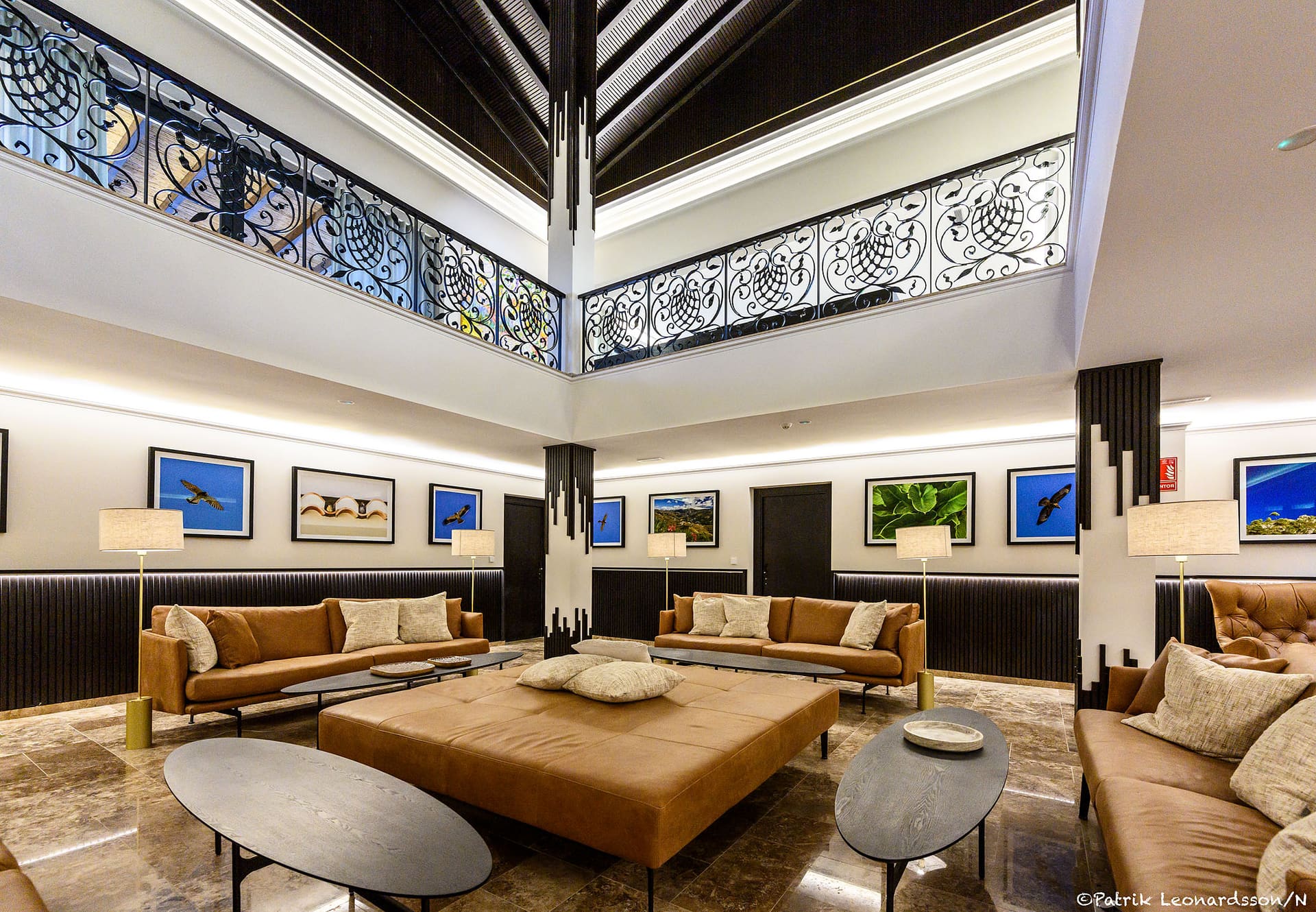 The lounge at the foot of the atrium, the wrought-iron gallery above.